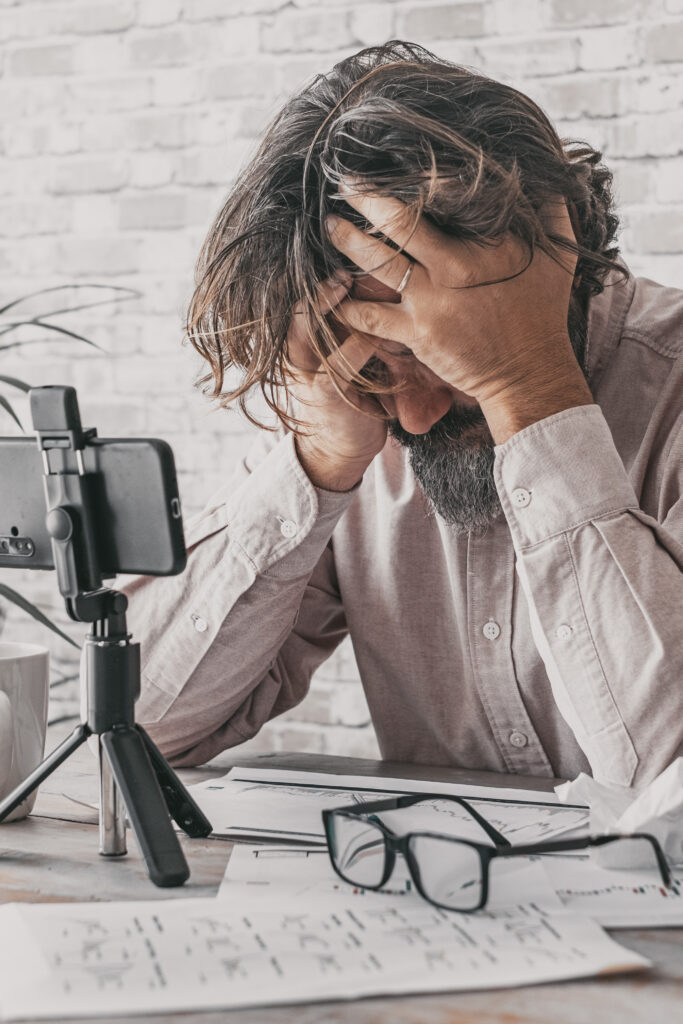 Man working at home on the table with desperate expression and p